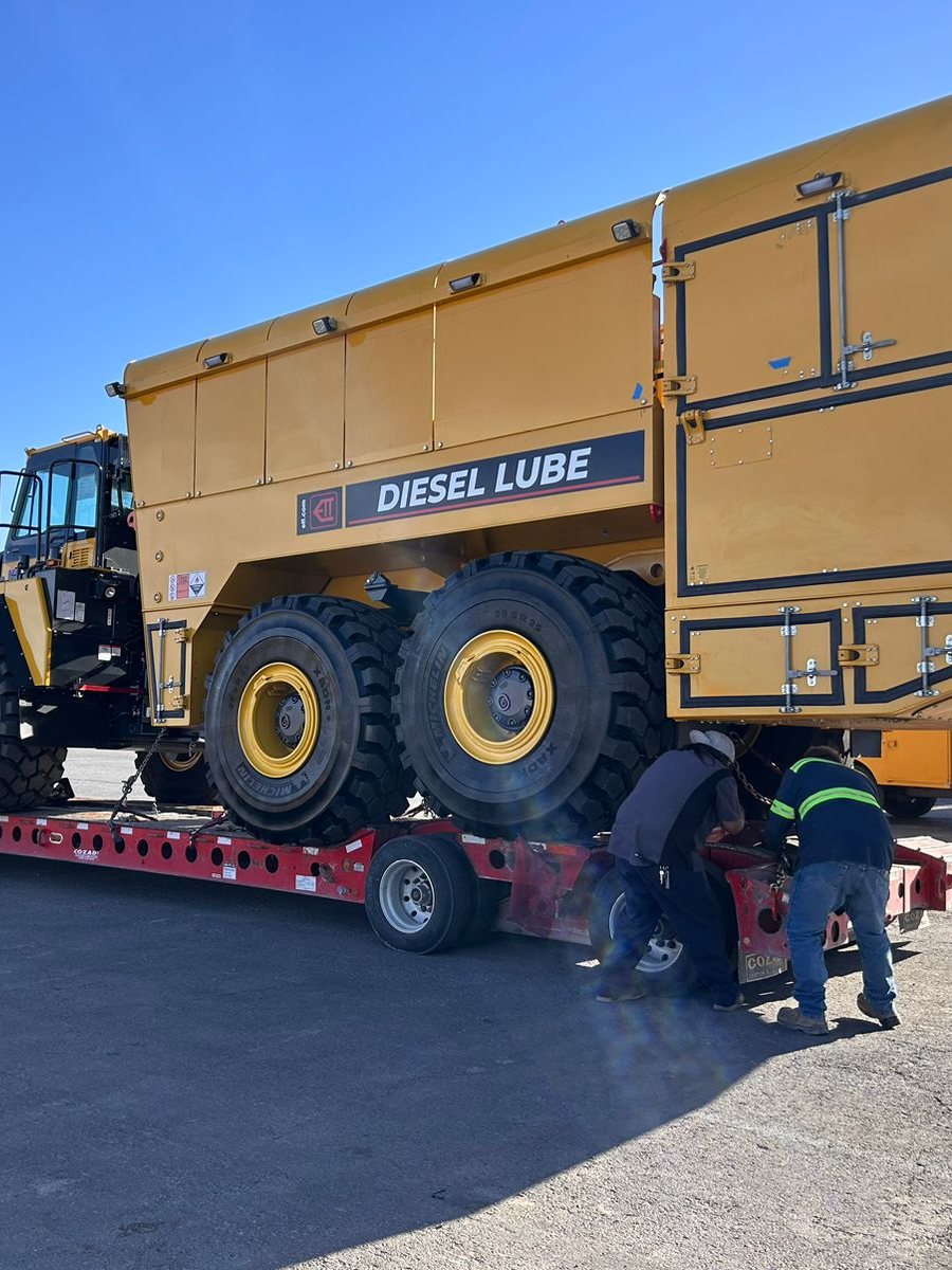 Mining equipment tank loaded on a lowboy trailer, secured and ready for transport